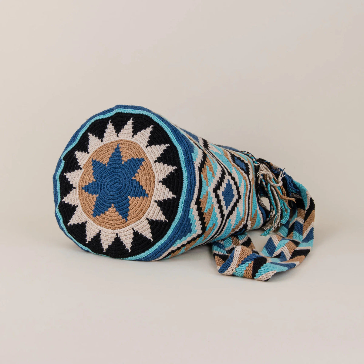 Bottom view of Bahía Concha Wayuu Mochila showing circular blue, beige and black handwoven design – Maison Monserrate