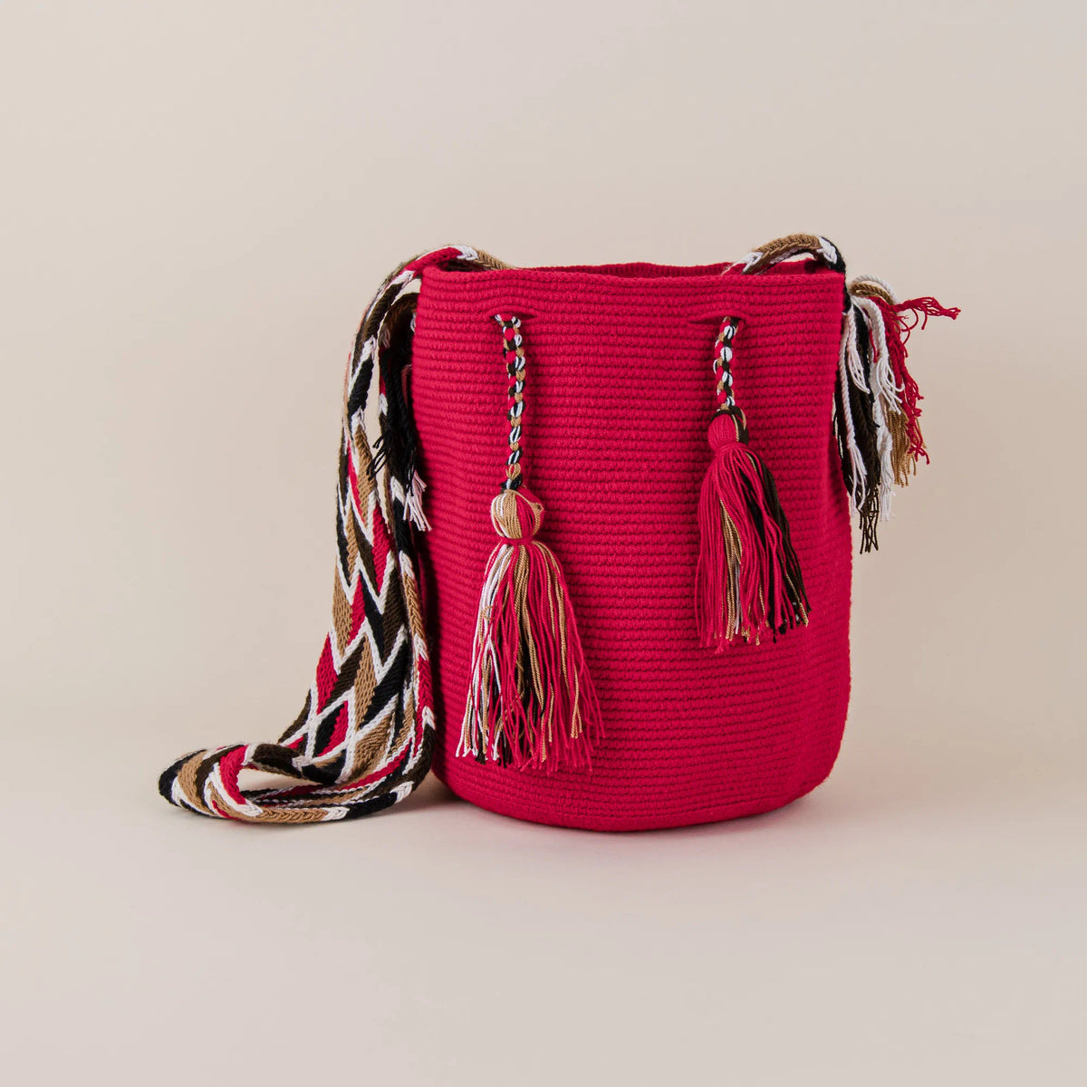 Front view of Baranoa Wayuu Mochila with red handwoven body, decorative tassels and geometric shoulder strap – Maison Monserrate