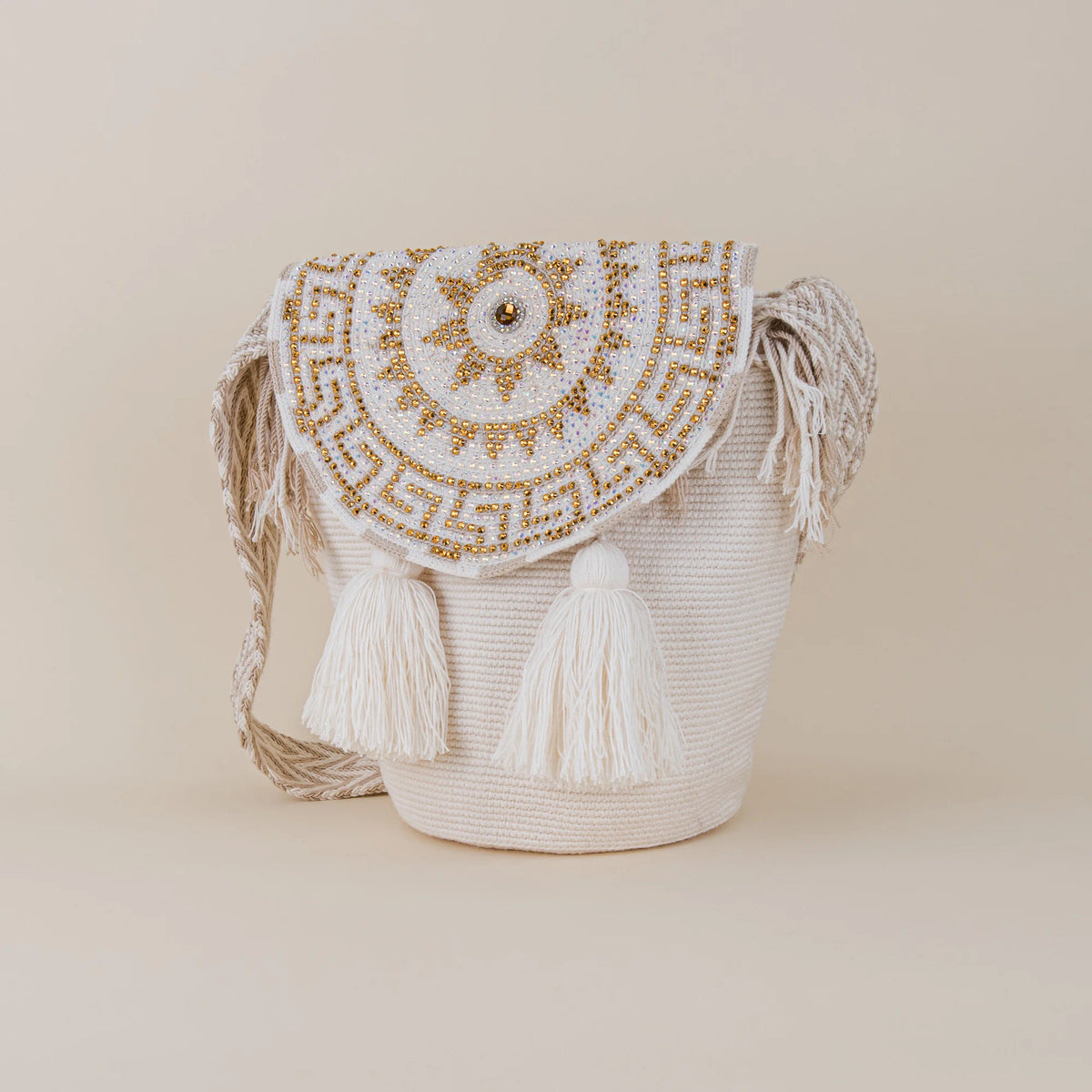 Angled view of Fusa Wayuu Mochila with Lid featuring gold and iridescent crystal embellishments and white tassels – Maison Monserrate