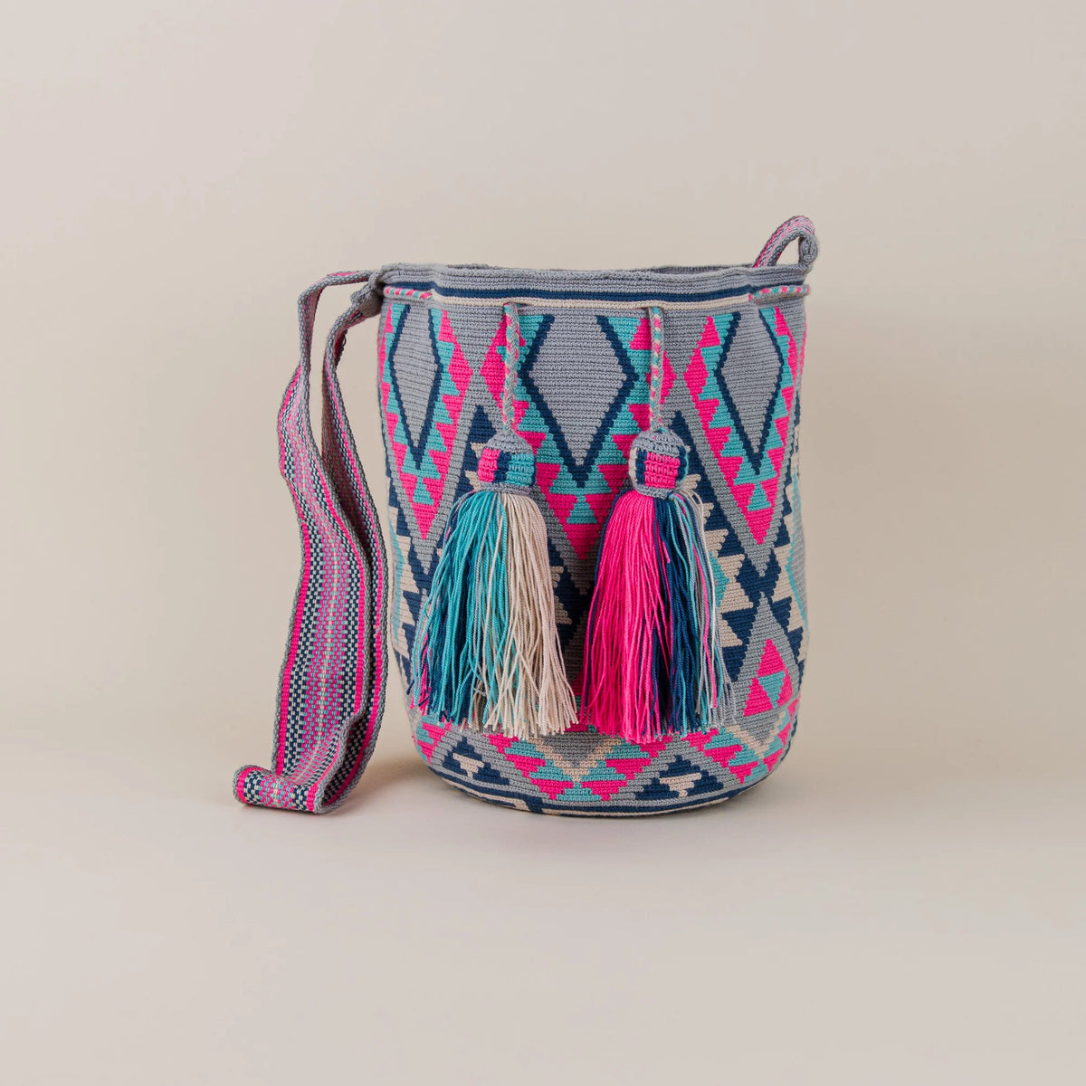 Front view of Manati Wayuu Mochila featuring geometric handwoven patterns, colorful tassels and woven shoulder strap – Maison Monserrate