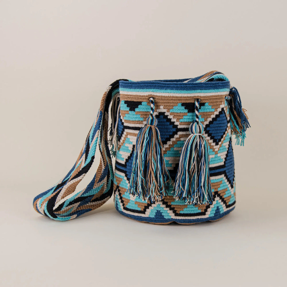 Front view of Pasto Wayuu Mochila with geometric handwoven pattern, multicolor tassels and woven shoulder strap – Maison Monserrate