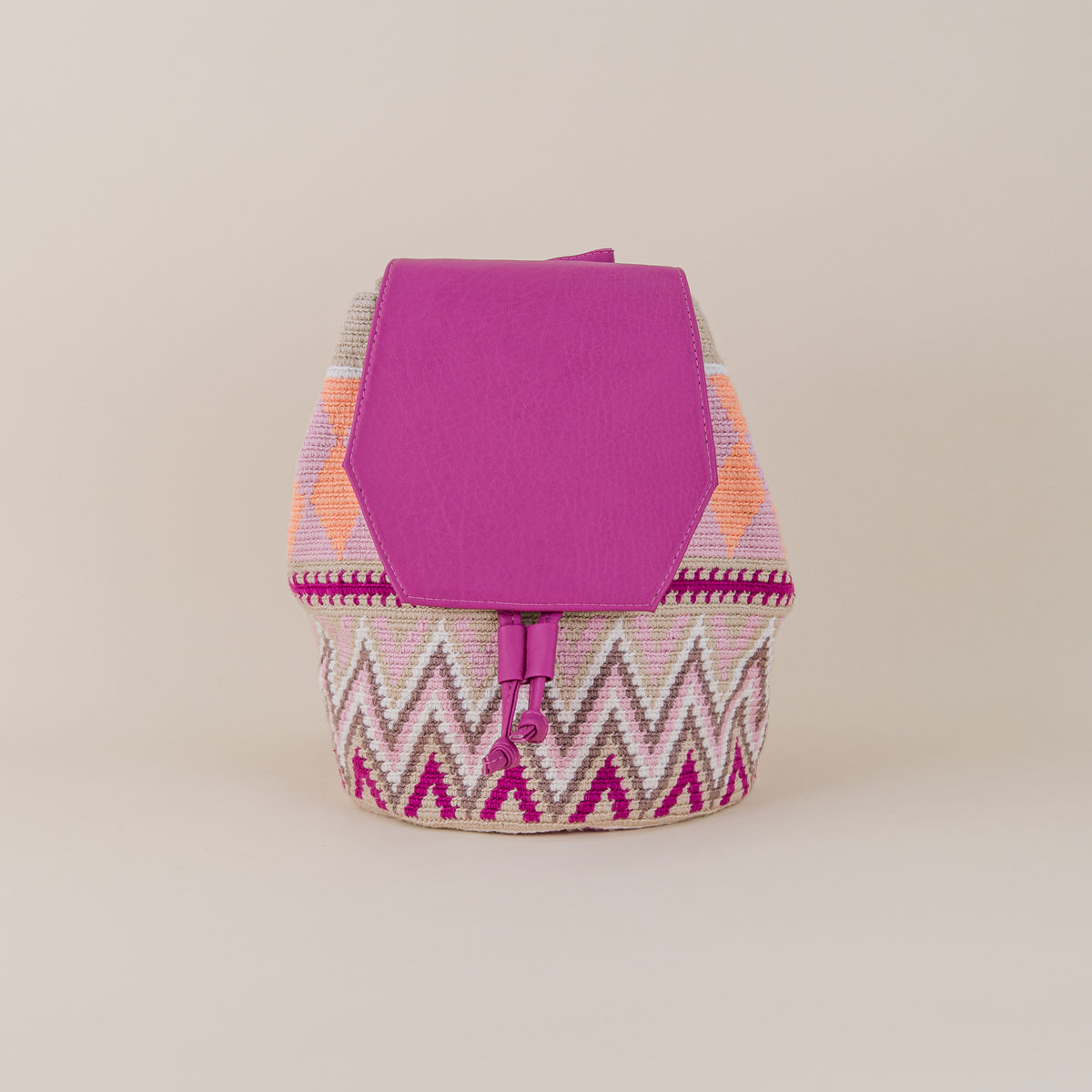 Front view of Sincelejo Wayuu Backpack with pink, cream and orange handwoven geometric pattern and fuchsia flap – Maison Monserrate