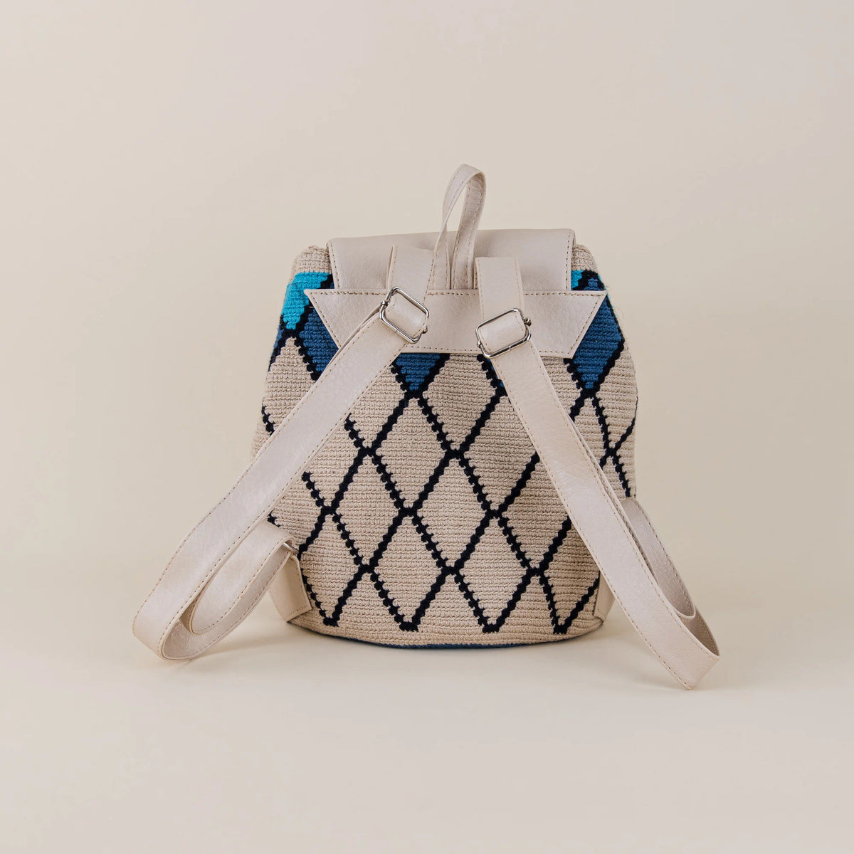 Back view of Coveñas Wayuu Backpack showing beige and navy handwoven pattern with adjustable cream shoulder straps – Maison Monserrate