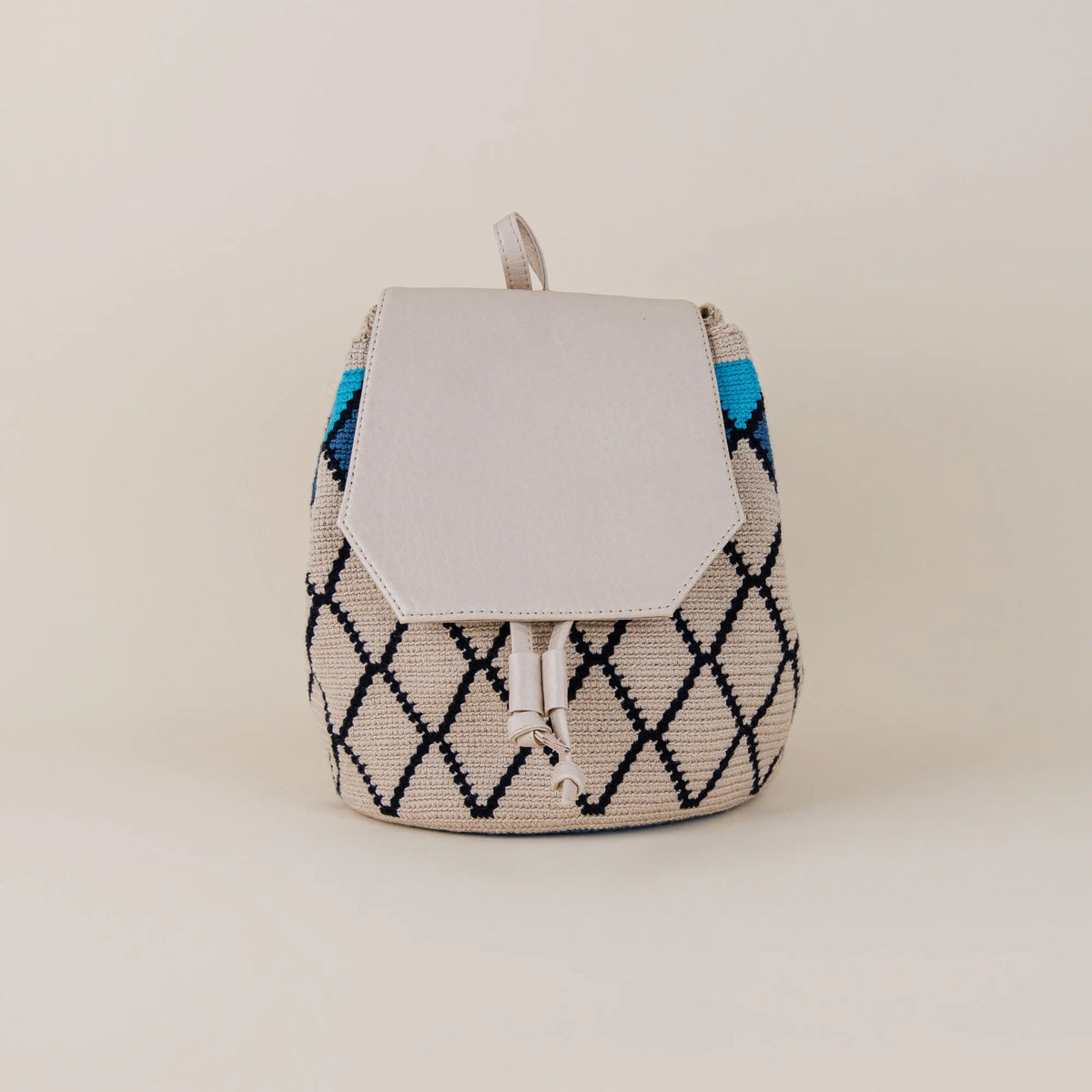 Front view of Coveñas Wayuu Backpack with beige and navy geometric handwoven pattern, blue accents and cream flap – Maison Monserrate