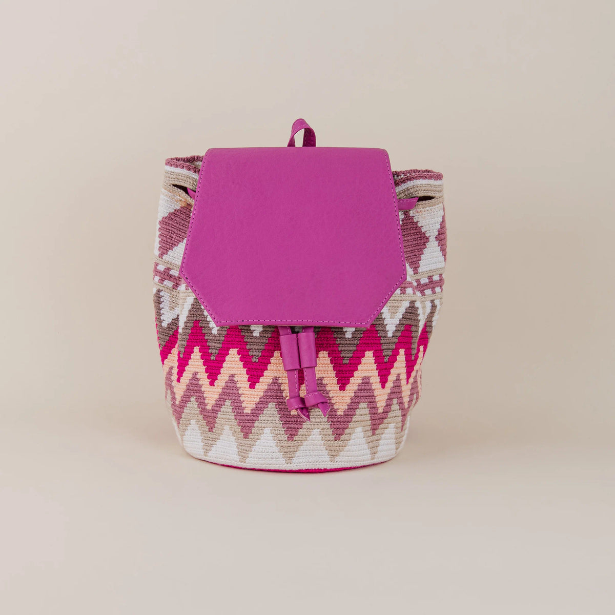 Front view of Mompox Wayuu Backpack with pink, cream and fuchsia handwoven geometric pattern and fuchsia flap – Maison Monserrate