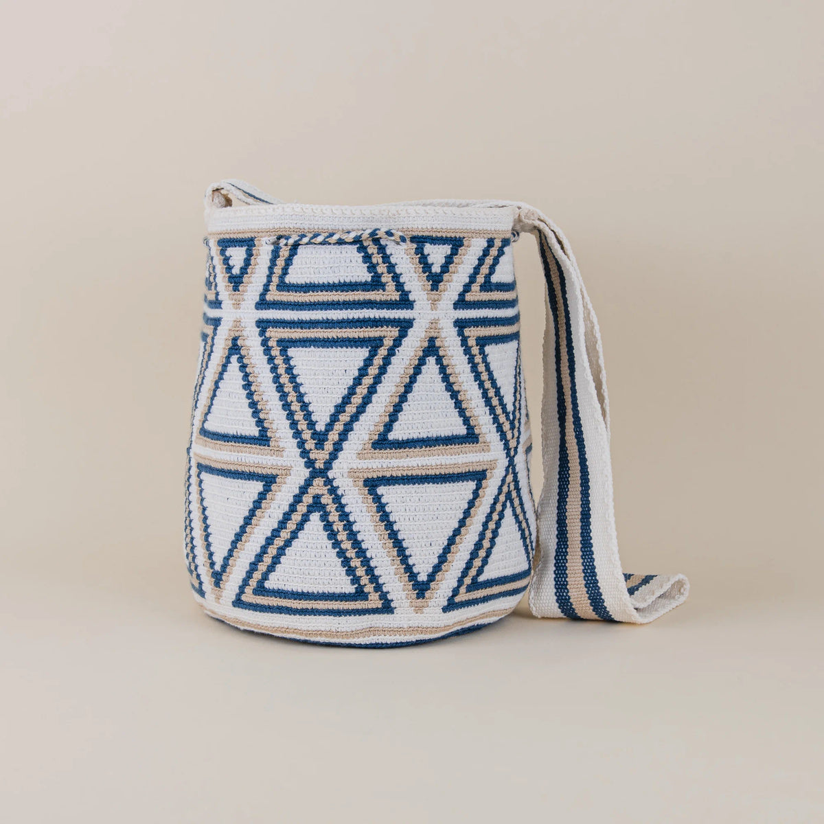 Back view of Monteria Wayuu Mochila showing navy blue, ivory and beige geometric handwoven design and woven shoulder strap – Maison Monserrate