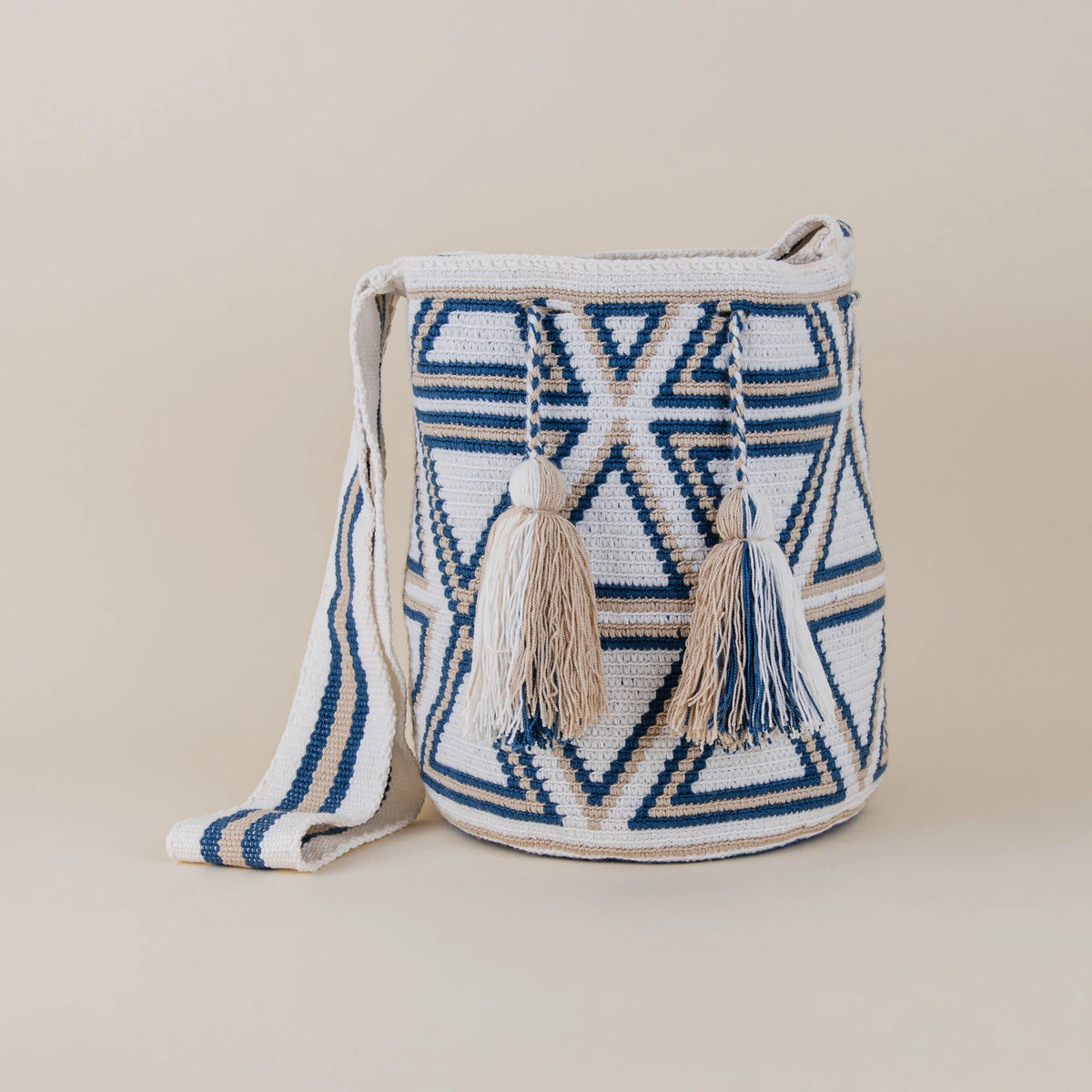 Front view of Monteria Wayuu Mochila with navy blue, ivory and beige geometric handwoven patterns and tassels – Maison Monserrate