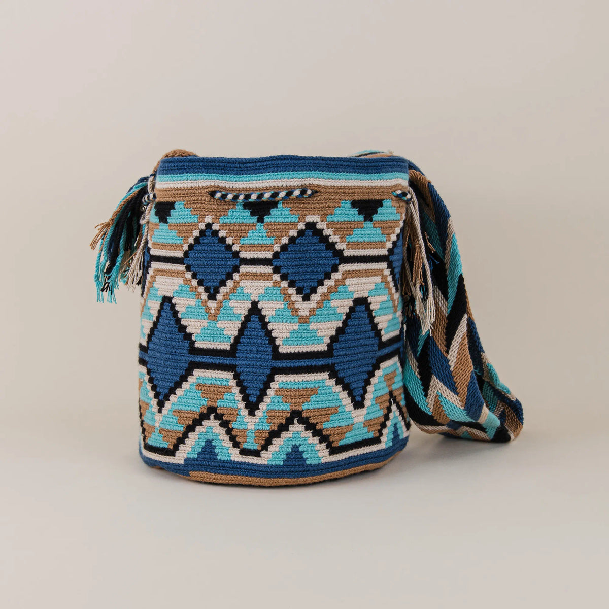 Back view of Pasto Wayuu Mochila showing intricate blue, turquoise, black and beige geometric weaving – Maison Monserrate