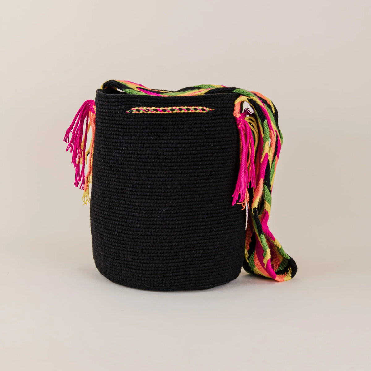 Back view of Puerto Colombia Wayuu Bag showing its black handwoven construction and colorful woven shoulder strap – Maison Monserrate