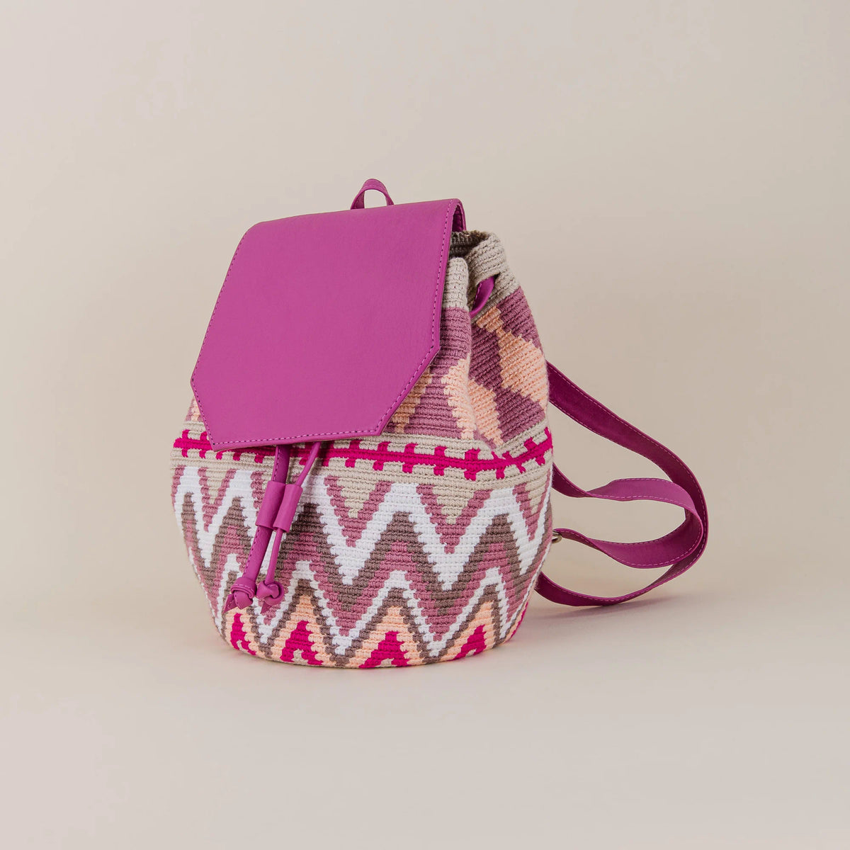 Angled view of Riohacha Wayuu Backpack showing handwoven geometric pattern, fuchsia flap and adjustable shoulder straps – Maison Monserrate