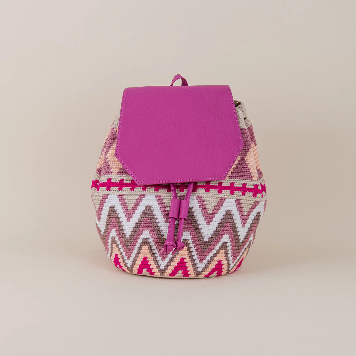 Front view of Riohacha Wayuu Backpack with pink, cream and fuchsia handwoven geometric pattern and fuchsia flap – Maison Monserrate