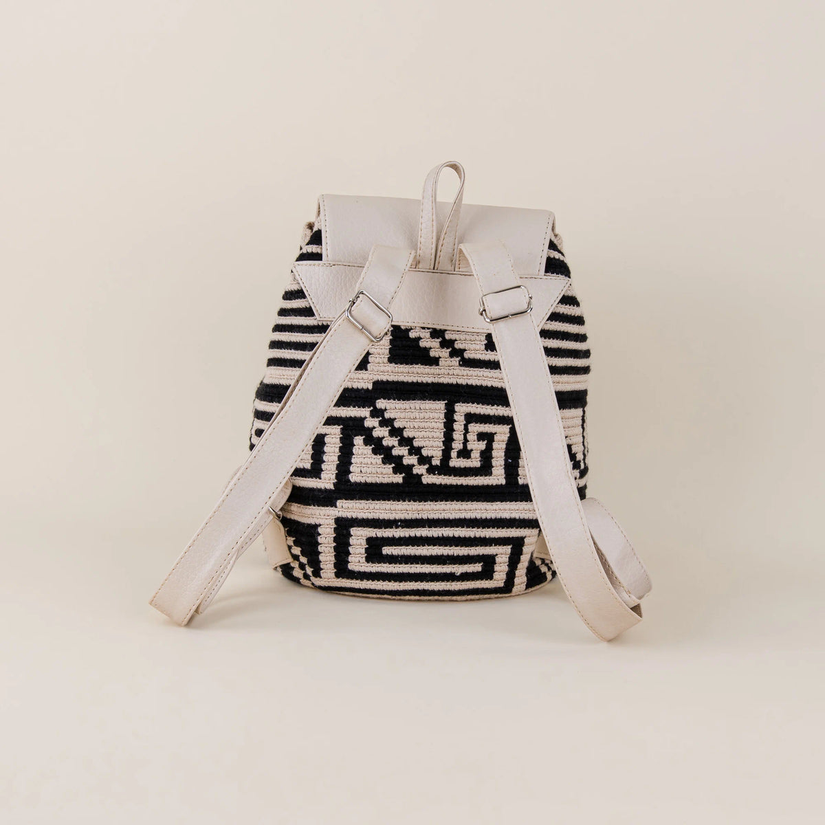 Back view of Tolú Wayuu Backpack showing black and cream handwoven pattern with adjustable cream shoulder straps – Maison Monserrate