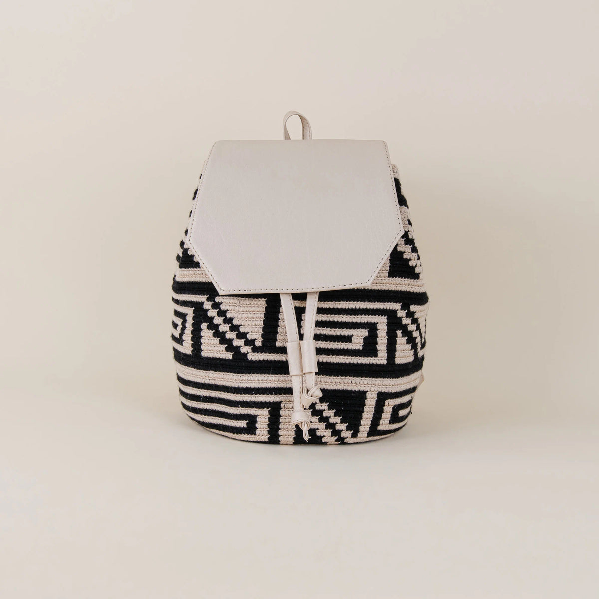 Front view of Tolú Wayuu Backpack with black and cream geometric handwoven pattern and cream flap – Maison Monserrate